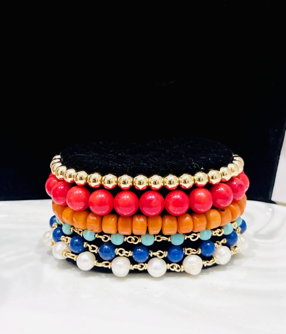 Corals, magnesites, mountain jade and high quality gold-bonded beads. Elastic and wire wrapped mix.