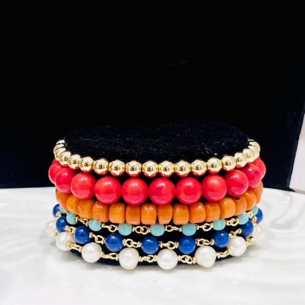 Corals, magnesites, mountain jade and high quality gold-bonded beads. Elastic and wire wrapped mix.